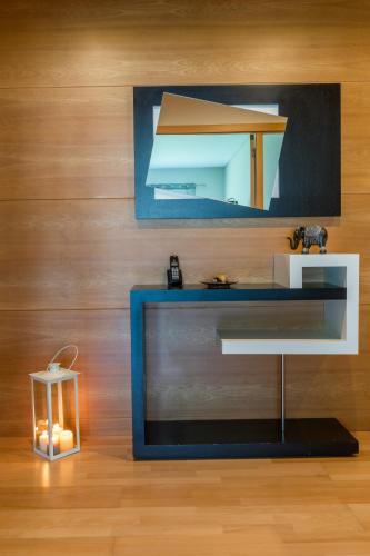 a table with a mirror and a candle in a room at Casa do Pico do Salomao in Ponta Delgada