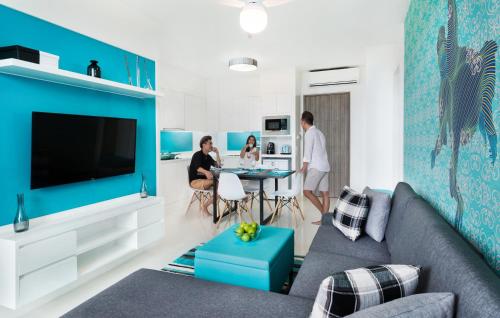 a living room with a blue accent wall at Cassia Bintan, part of Banyan Group in Lagoi