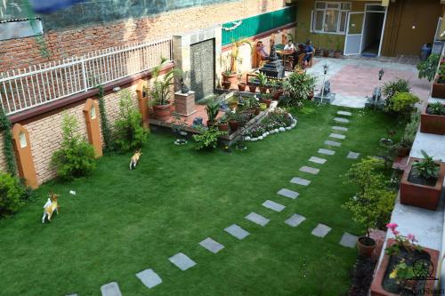 an aerial view of a backyard with two dogs on the grass at Aarya Chaitya Inn in Kathmandu