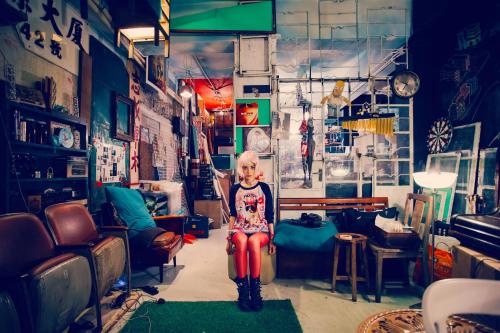 a child sitting on a stool in a room at Wontonmeen in Hong Kong