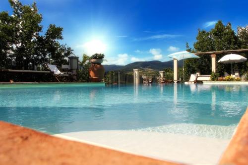 una piscina de agua azul en un complejo en Residence il Poggiolino, en Montecarelli