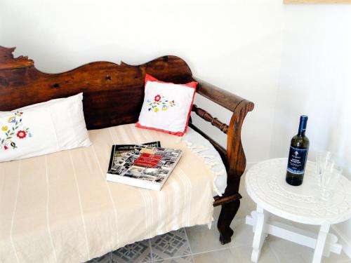a bedroom with a bed with a book and a table at Thera Incognita Studios in Perissa