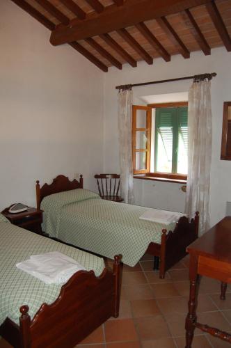 a bedroom with two beds and a window at Marinho in Cavo