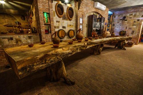 a long wooden table with vases on it in a room at Marani Hotel in Batumi