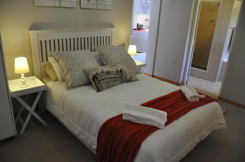 a bedroom with a bed with pillows and a table at Sedgefield Island Villa in Sedgefield