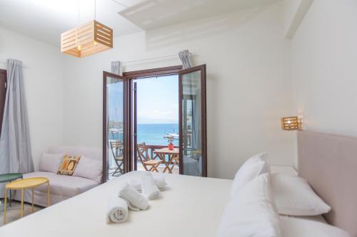 a bedroom with a bed and a view of the ocean at Amalthia Luxury Studios in Naxos Chora