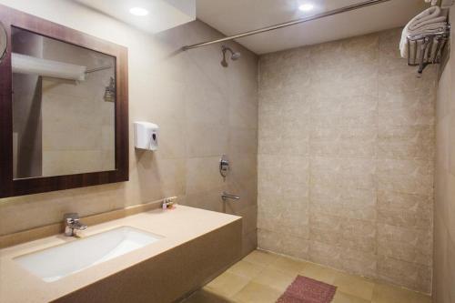 a bathroom with a sink and a mirror at Hotel Forest Avenue - Best Luxury Hotel in Dehradun in Dehradun