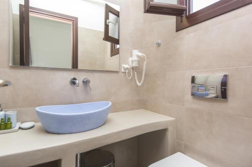 a bathroom with a blue bowl sink on a counter at Amalthia Luxury Studios in Naxos Chora