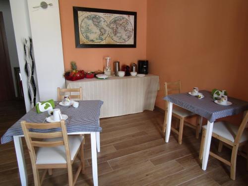 a dining room with two tables and two chairs at Il Batacchio B&B in Minerbio