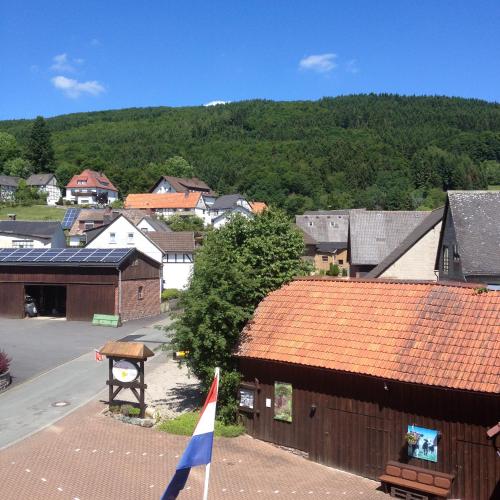 a view of a town with a flag on a building at fun4all-holidayhome in Medebach