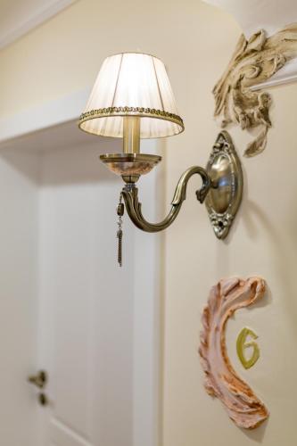 a lamp hanging on a wall with a fish on it at Schlosstaverne in Braunau am Inn
