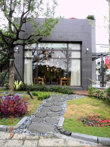 a stone walkway in front of a building at Green Life Spa Hot Spring Hotel in Jiaoxi