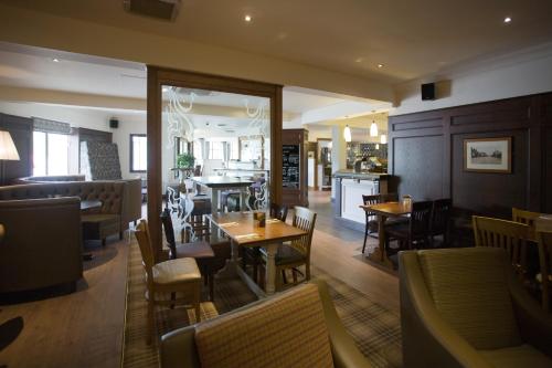 a dining room with tables and chairs in a restaurant at The Fairway in Barnsley