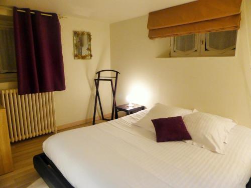 a bedroom with a white bed with a pillow on it at Chambre d'Hote Saint Malo in Saint Malo