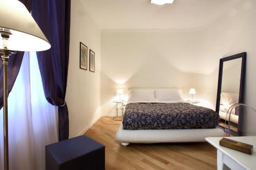 a bedroom with a bed and a large mirror at R&B Santo Stefano in Bologna