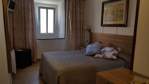 Ένα ή περισσότερα κρεβάτια σε δωμάτιο στο Hotel La Residencia