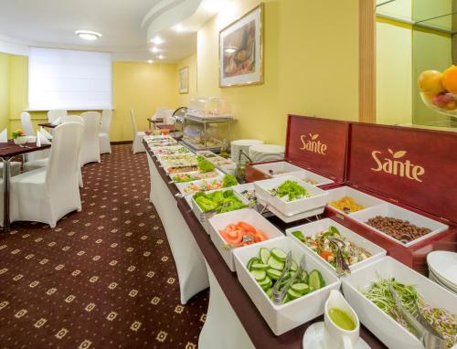 a buffet line with food in a restaurant at Hotel Reytan in Warsaw