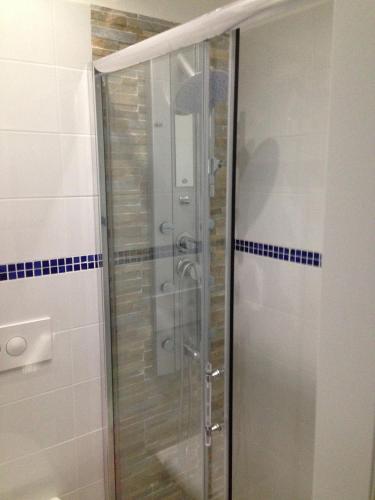 a shower with a glass door in a bathroom at Hotel Viking in Rimini