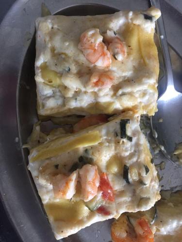 three slices of pizza with shrimp on a plate at Hotel Viking in Rimini