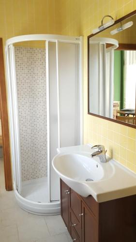 a bathroom with a white sink and a shower at Apartamentos Hacienda de Arna in Somo