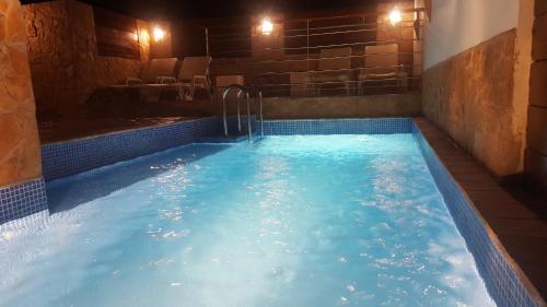 a hot tub with blue water in a room at Seaview Guesthouse in Olhão