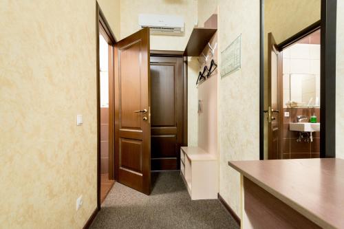 a bathroom with a wooden door and a sink at Shale on Komsomolsky in Novosibirsk