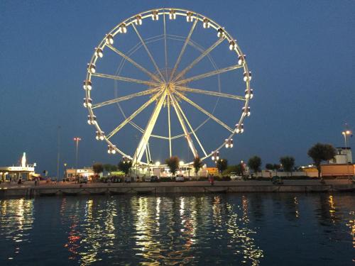 a large ferris wheel in the water at night at Hotel Viking in Rimini