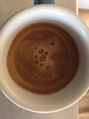 a cup of coffee with a smiley face in it at Hotel Viking in Rimini