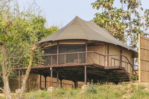 a round building with a roof on a field at Jagatpur Lodge by Annapurna in Khargauli