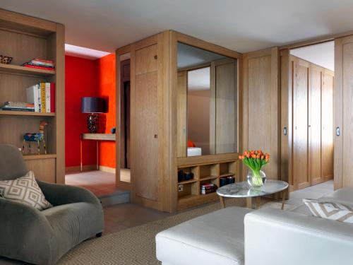 a living room with a couch and a table at The Marylebone Hotel in London