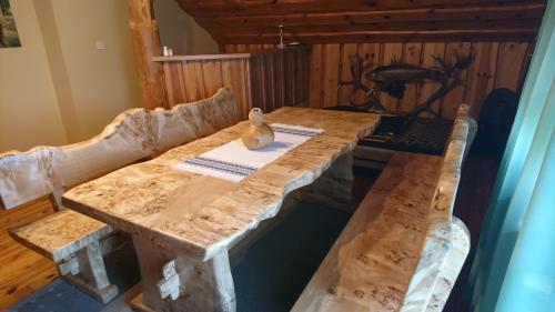 a wooden table with a vase sitting on top of it at Apartment Kostolic in Gajić