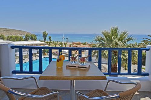a table on a balcony with a view of the ocean at Akti Aegeou in Agios Sostis