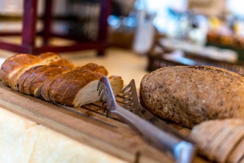 a tray of bread and a fork on a table at Swiss Historic Hotel Masson in Montreux