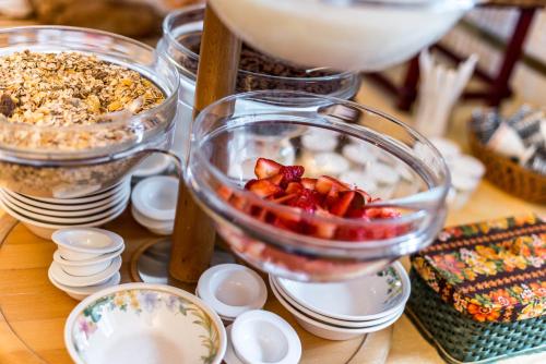 a table with a bowl of food with strawberries in it at Swiss Historic Hotel Masson in Montreux