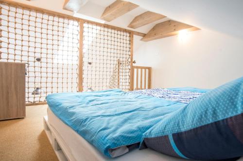 a bedroom with a bed with a blue comforter at Apartment Jelena1 in Tatranská Lomnica
