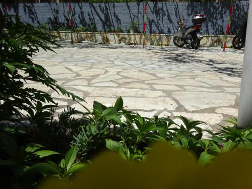a scooter is parked on a stone patio at Elena Rista Studios in Parga