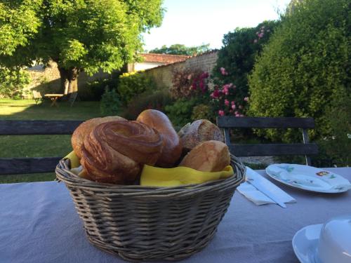 a basket of bread sitting on a table at La Madeleine in La Jarrie