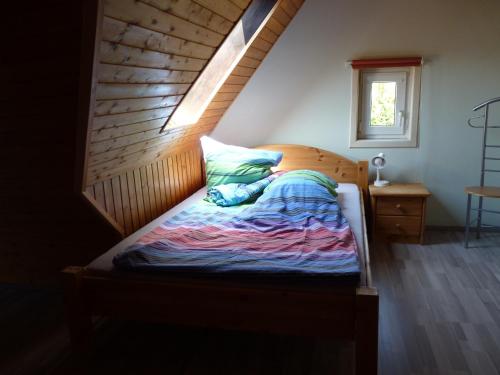 a bedroom with a bed with a wooden headboard at Ferienhaus Katharina in Nothweiler