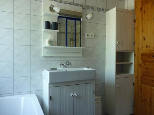 a bathroom with a sink and a mirror at Ferienhaus Katharina in Nothweiler