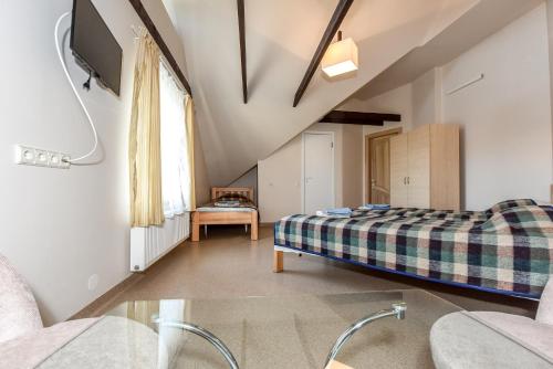 a bedroom with a bed and a tv in a room at Holiday house KNP in Palanga