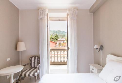 a bedroom with a bed and a window with a view at B&B La Sosta degli Artisti in Pietrasanta