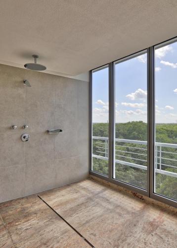 a large bathroom with a shower and large windows at SOALTEE Hotel by Trip Inn Frankfurt Messe Tagungshotel in Frankfurt/Main