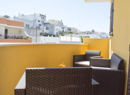 two chairs and a table on a balcony at Chiardiluna in Castro di Lecce