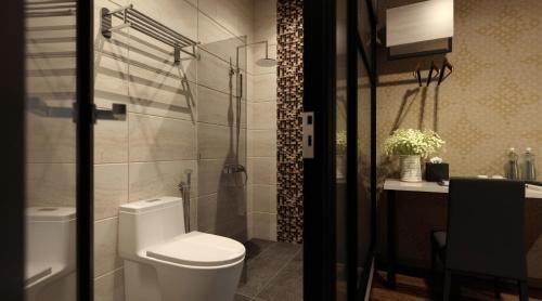 a bathroom with a toilet and a shower and a sink at The Square Hotel in Skudai