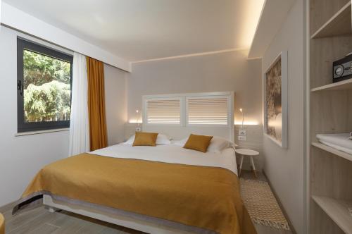 a bedroom with a large bed with a window at Villas Bellevue Plava Laguna in Poreč