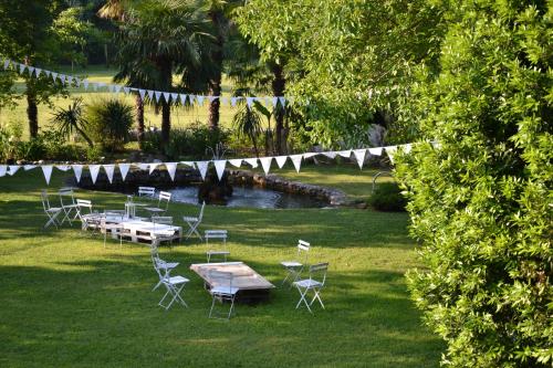 a group of tables and chairs in a field with flags at da Gastone in Rivignano