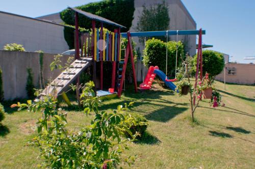 a playground in a yard with a slide at Hotel Stadt Emmerich in Emmerich