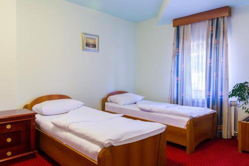 Postel nebo postele na pokoji v ubytování Hotel Sunce Sarajevo Vogosca