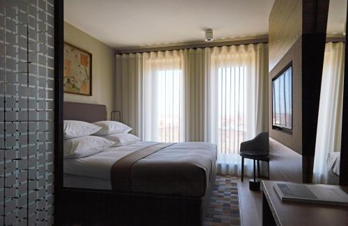 a hotel room with a bed and a window at PURO Gdańsk Stare Miasto in Gdańsk