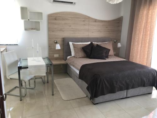 a bedroom with a bed and a table and a desk at Apartments Maritea in Vodice